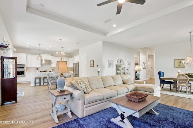 living area with recessed lighting, visible vents, and light wood-style flooring