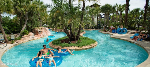 view of pool with a water play area