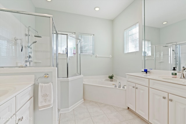 full bath featuring a stall shower, tile patterned flooring, two vanities, and a sink