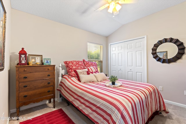 bedroom featuring ceiling fan, carpet floors, baseboards, vaulted ceiling, and a closet