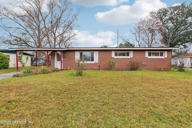 ranch-style home with a front lawn, a carport, and brick siding