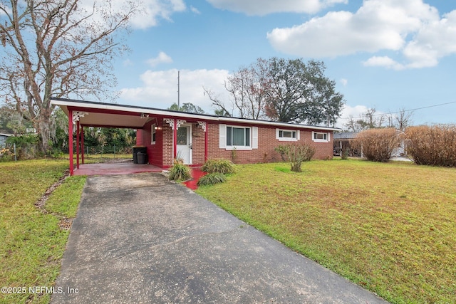 single story home featuring driveway, a carport, a front lawn, and brick siding