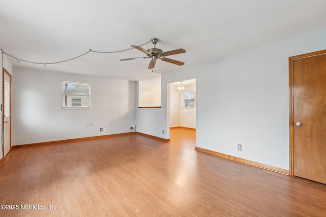 unfurnished room featuring a ceiling fan, baseboards, and light wood finished floors