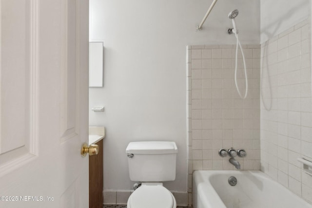 bathroom featuring toilet, baseboards,  shower combination, and vanity