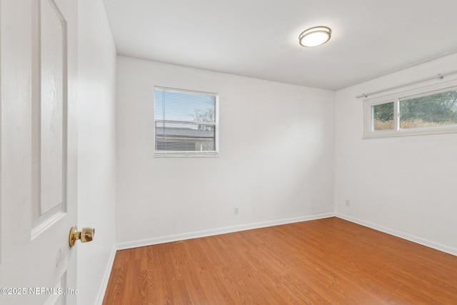 empty room with baseboards and wood finished floors