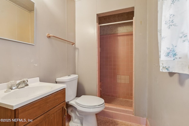 full bathroom with a stall shower, vanity, and toilet