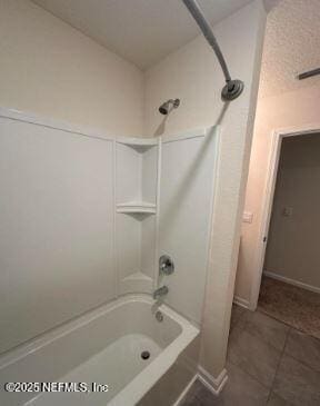 full bathroom featuring tile patterned flooring, baseboards, and shower / bathtub combination