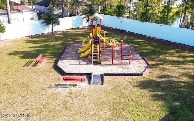 view of playground featuring fence and a yard