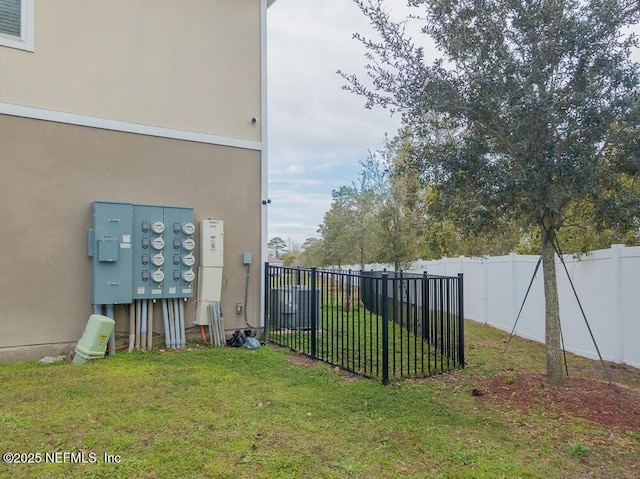 view of yard with a fenced backyard and visible vents