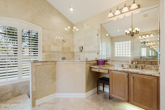 full bathroom with visible vents, vaulted ceiling, vanity, a chandelier, and a walk in shower