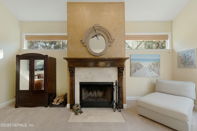 living area with carpet floors, a wealth of natural light, and baseboards