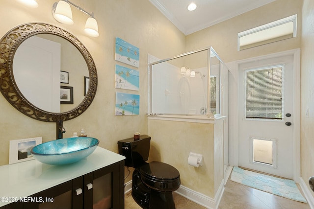 bathroom with crown molding, toilet, a stall shower, vanity, and baseboards