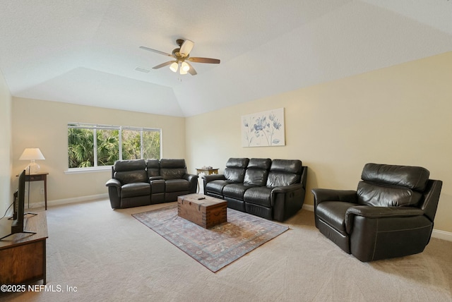 living room with lofted ceiling, carpet floors, visible vents, a ceiling fan, and baseboards