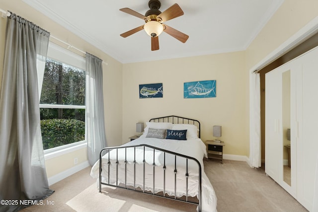 carpeted bedroom featuring baseboards, ornamental molding, and a ceiling fan