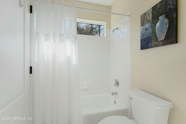 bathroom featuring shower / tub combo with curtain and toilet