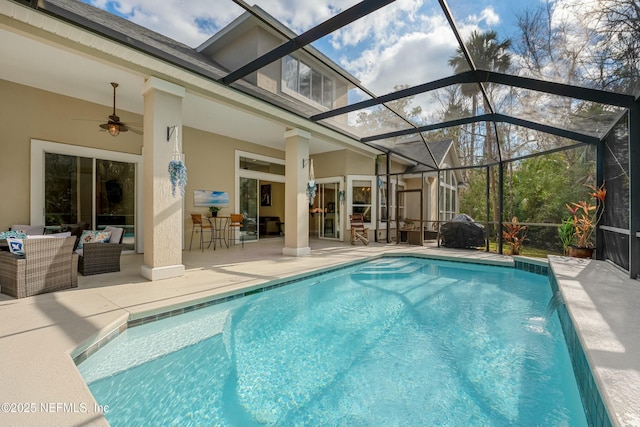 outdoor pool with a lanai, a patio, and ceiling fan