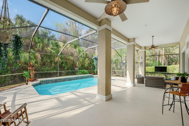 outdoor pool featuring a lanai, a ceiling fan, and a patio