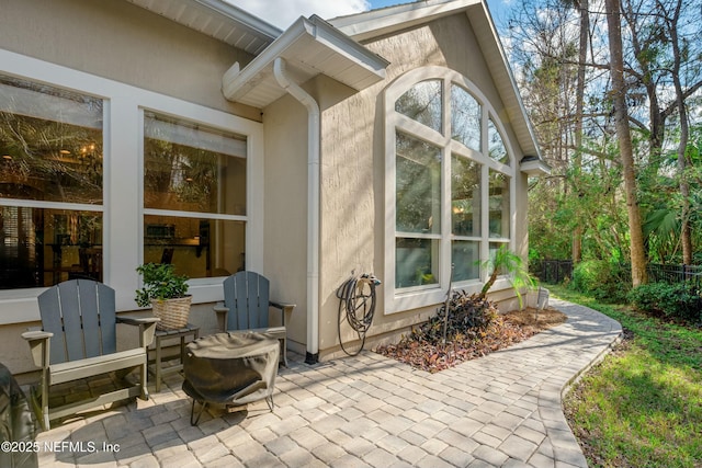 exterior space featuring stucco siding and a patio