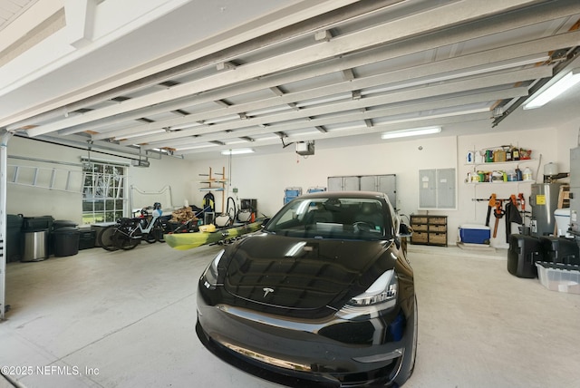 garage with water heater, electric panel, and a garage door opener