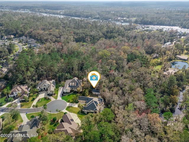 drone / aerial view with a residential view and a wooded view