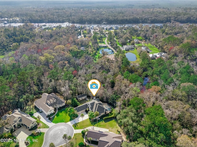 aerial view featuring a wooded view and a residential view