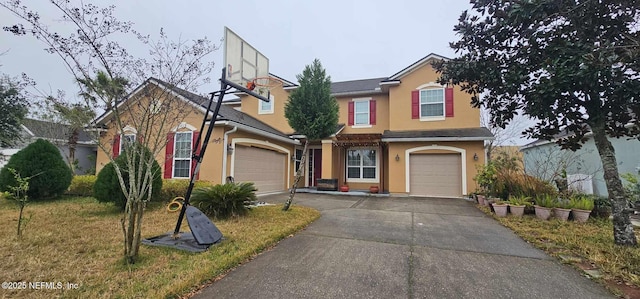 view of property featuring a front yard and a garage