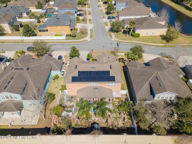 drone / aerial view featuring a water view and a residential view