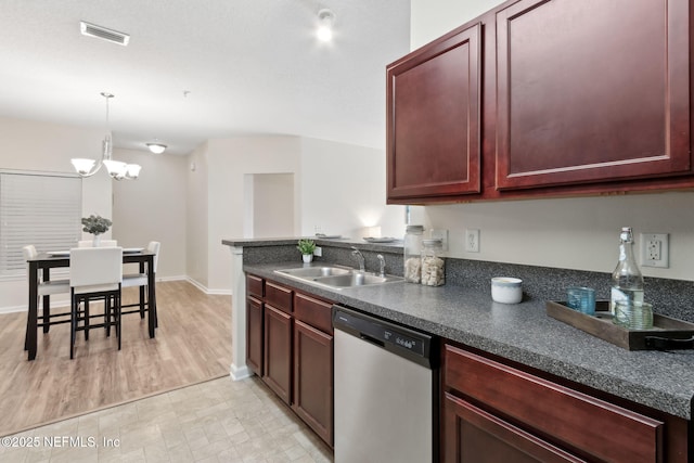 kitchen with a sink, visible vents, reddish brown cabinets, dishwasher, and dark countertops