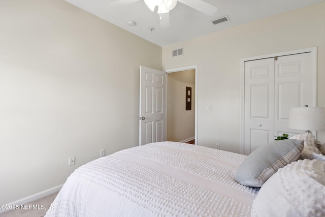 bedroom with carpet floors, baseboards, visible vents, and a closet