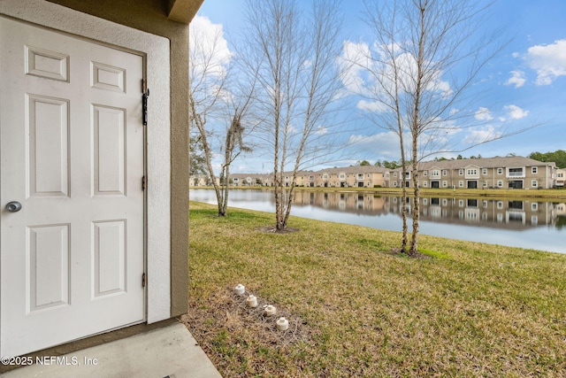 view of yard featuring a water view and a residential view