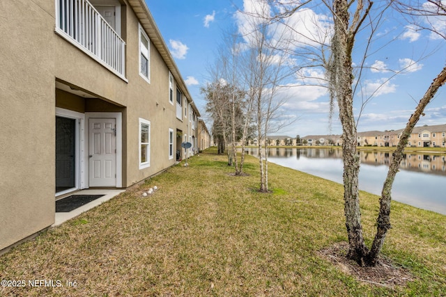 view of yard featuring a water view and a residential view