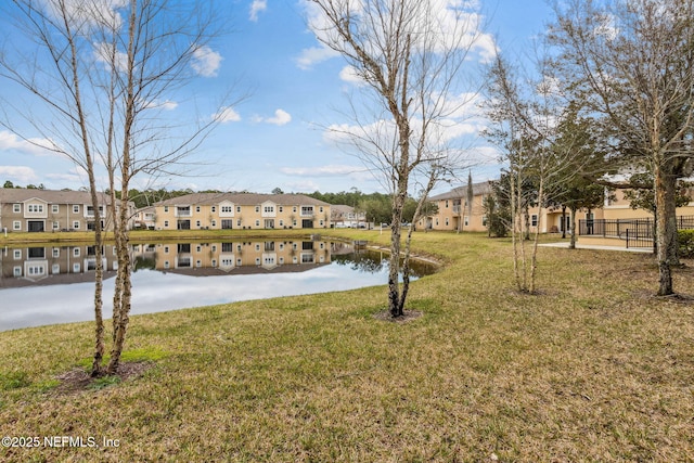 view of yard featuring a water view and a residential view