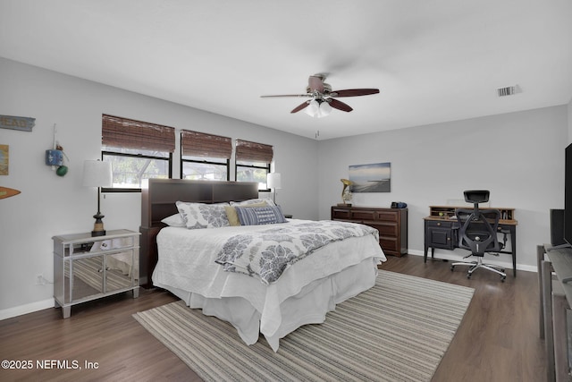 bedroom featuring ceiling fan, dark wood-type flooring, visible vents, and baseboards