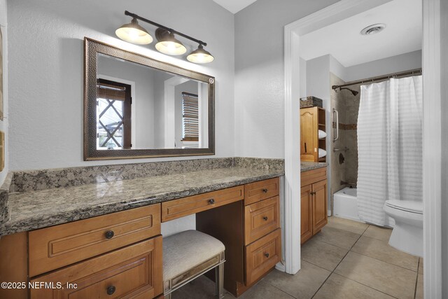 bathroom with toilet, vanity, visible vents, tile patterned floors, and shower / bath combo