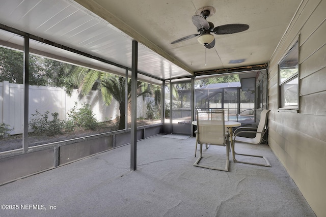 unfurnished sunroom featuring ceiling fan