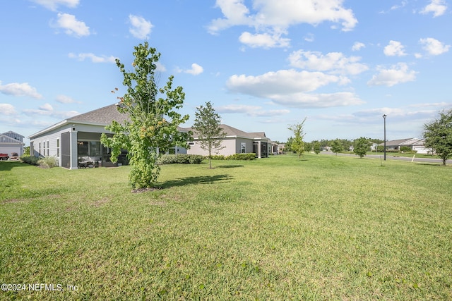 view of yard with a sunroom