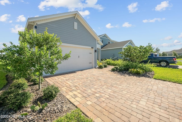 view of side of home featuring a garage