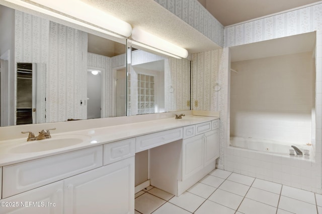 full bath with wallpapered walls, tiled tub, and a sink