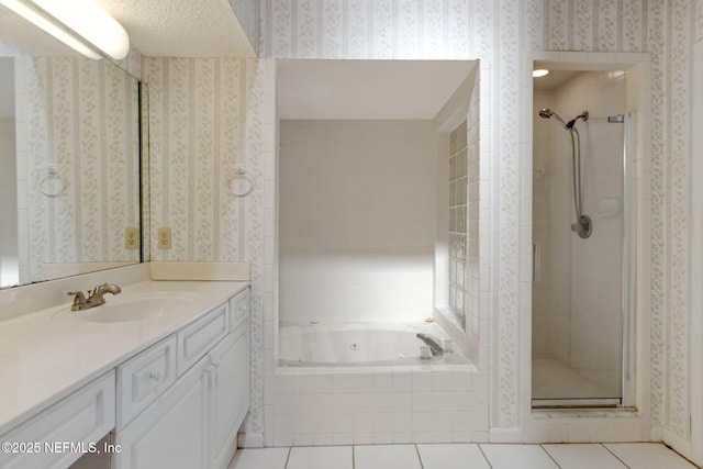 bathroom with a whirlpool tub, tile patterned flooring, vanity, and wallpapered walls