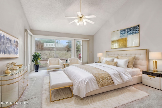 bedroom with lofted ceiling, a textured ceiling, a ceiling fan, and light colored carpet