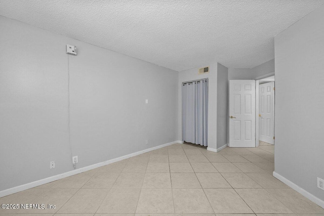 1255 Ponce Island Dr Unit C-733, Saint Augustine, FL 32084 - unfurnished bedroom with light tile patterned floors, baseboards, a textured ceiling, and visible vents
