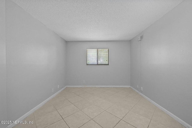 1255 Ponce Island Dr Unit C-733, Saint Augustine, FL 32084 - unfurnished room with light tile patterned flooring, a textured ceiling, and baseboards