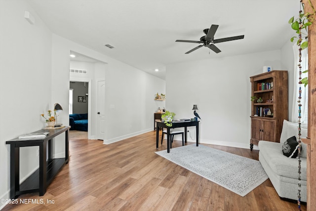 office area with visible vents, ceiling fan, baseboards, and wood finished floors