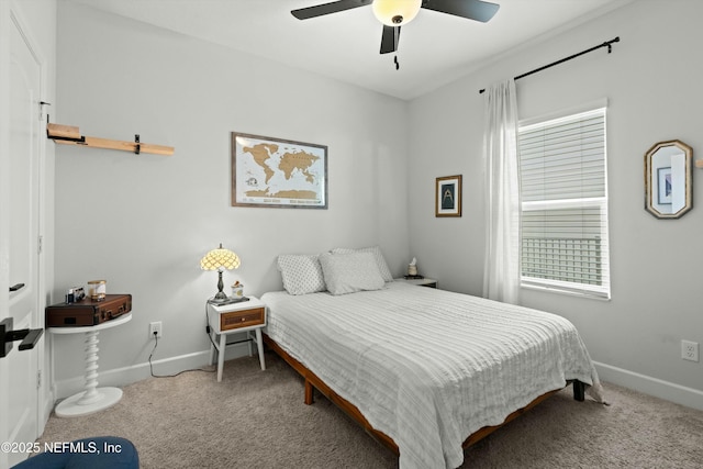 carpeted bedroom with a ceiling fan and baseboards