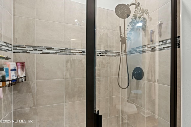 bathroom with a shower stall