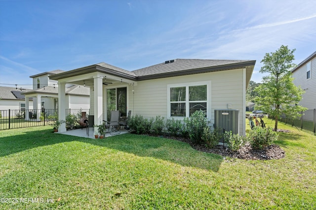 rear view of house featuring a lawn, a ceiling fan, a patio, fence, and central air condition unit