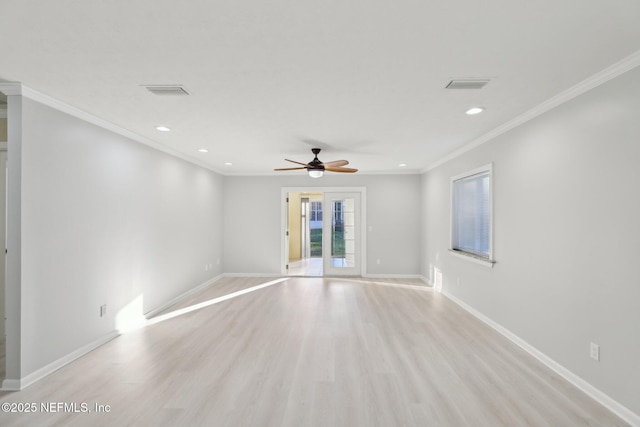 unfurnished room with baseboards, visible vents, crown molding, and light wood finished floors