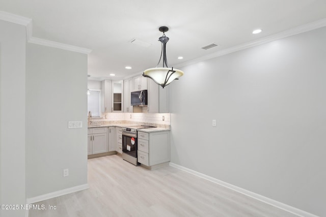 kitchen featuring hanging light fixtures, visible vents, ornamental molding, and stainless steel range with electric cooktop