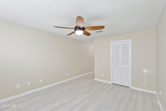 unfurnished bedroom with visible vents, baseboards, ceiling fan, light wood-type flooring, and a closet