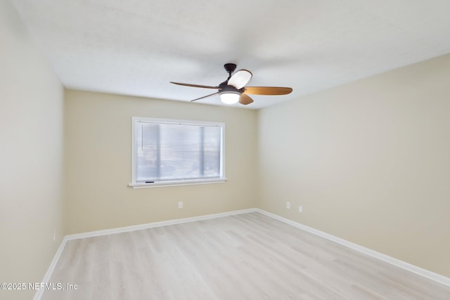 unfurnished room featuring ceiling fan, light wood-style flooring, and baseboards